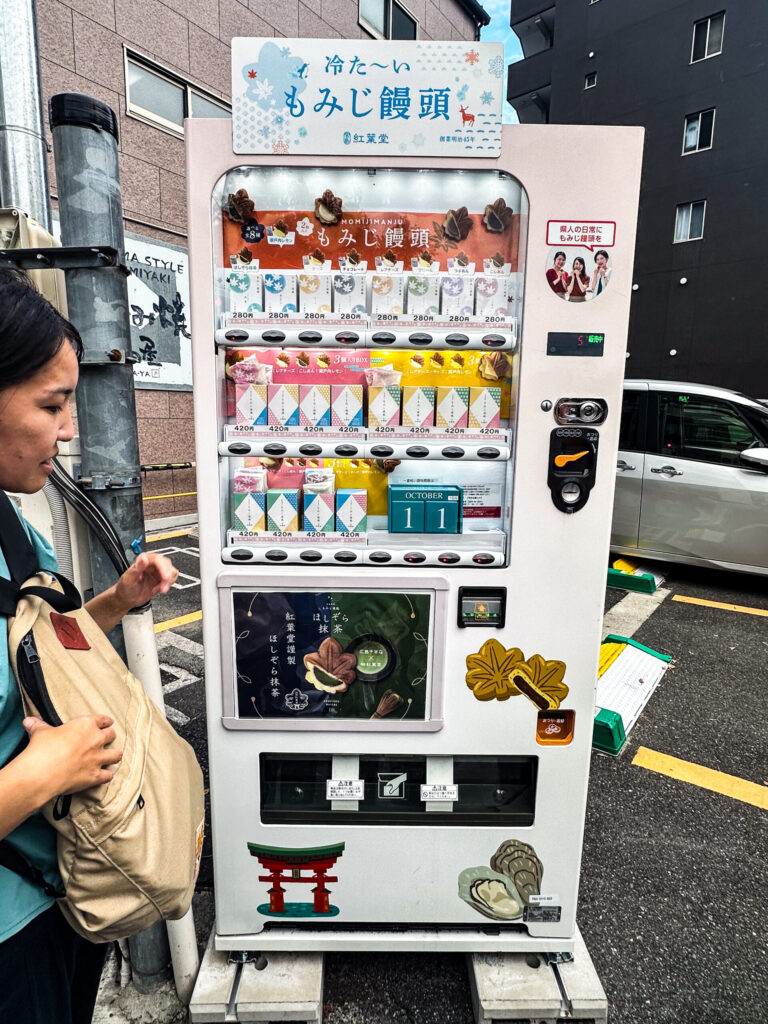 Ami showing us a vending machne that sells Momiji based sweets.
